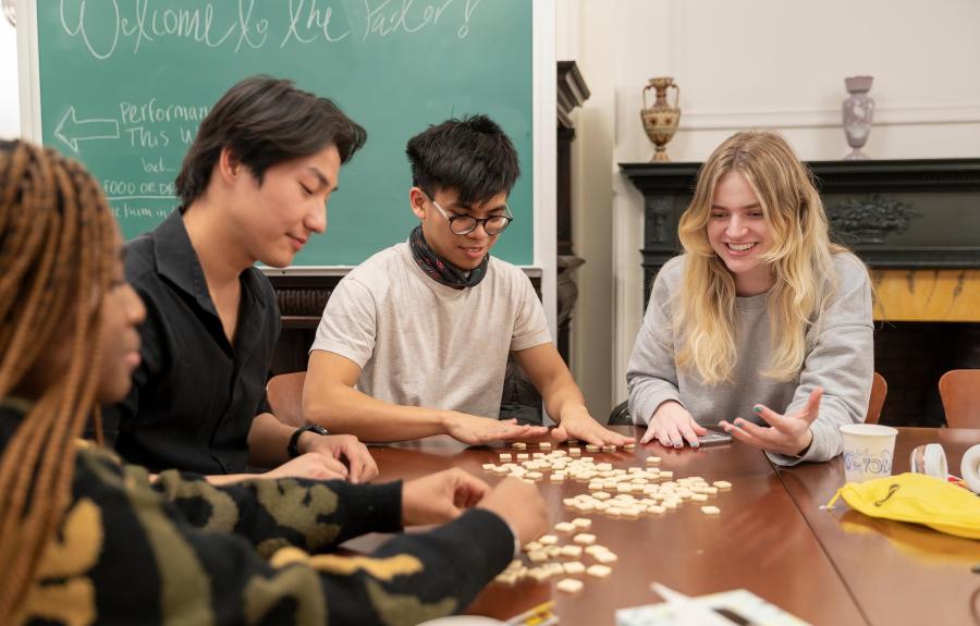 Milstein students play tabletop games with a Salon guest.  