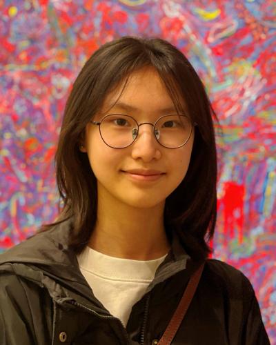 Joice Chen Portrait in front of colorful artwork