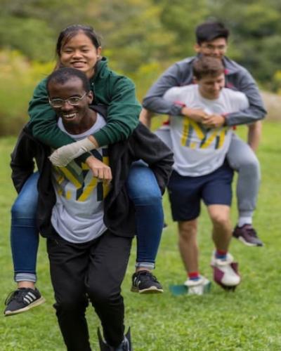 Students carrying each other through the ropes course
